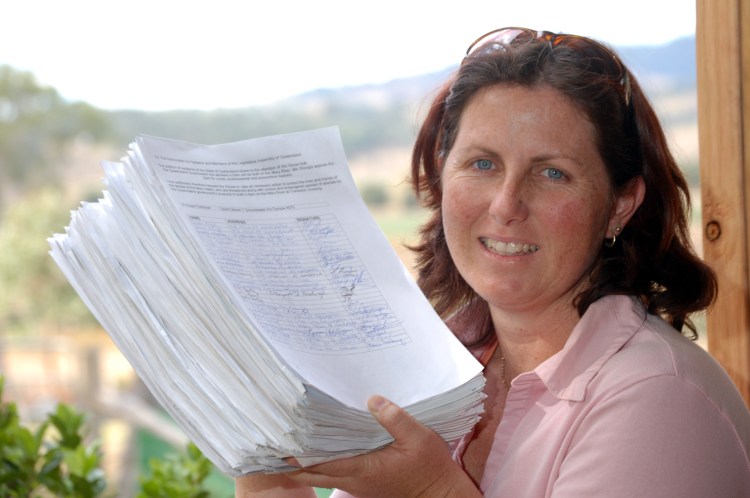 Melanie Larsen with the 15000 signatures against the Traveston Dam Melanie Larsen with the 15000 signatures against the Traveston Dam - Traveston Dam protest - June 2006 - Gympie Times collection