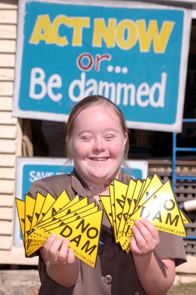 Vanessa holds up the No Dam stickers that are for sale for $1 Traveston Dam protest - May 2006 - Gympie Times collection